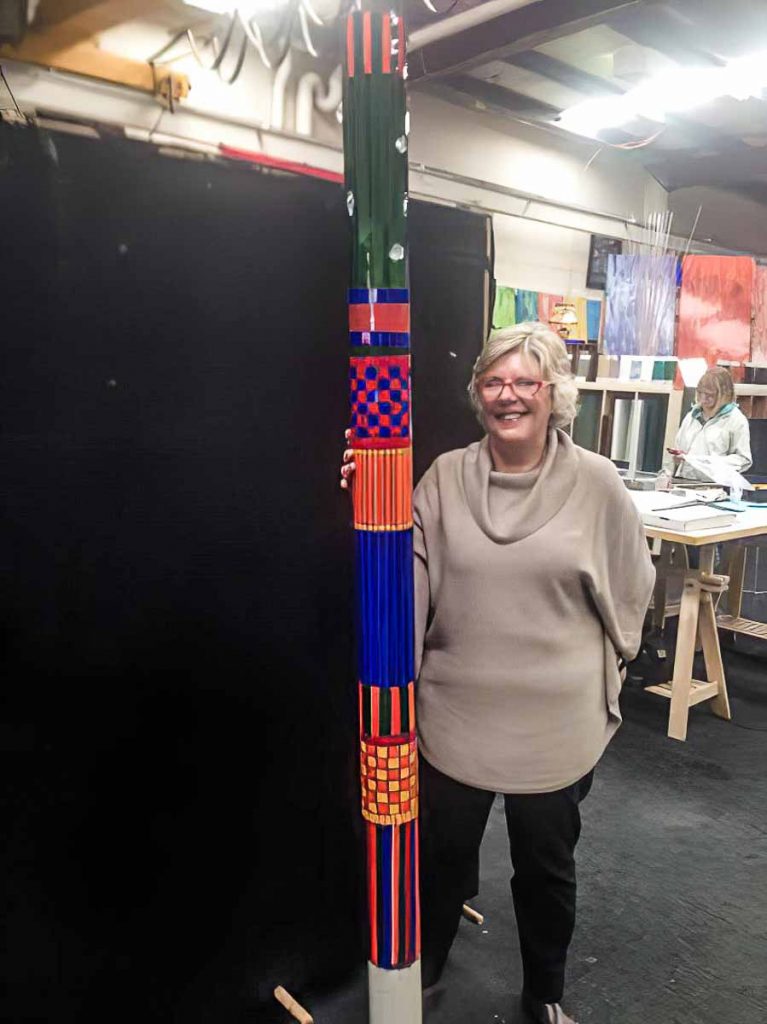 Artist: Elizabeth White with her completed mosaic totem pole. Monday afternoon mosaic classes at The Glass Emporium